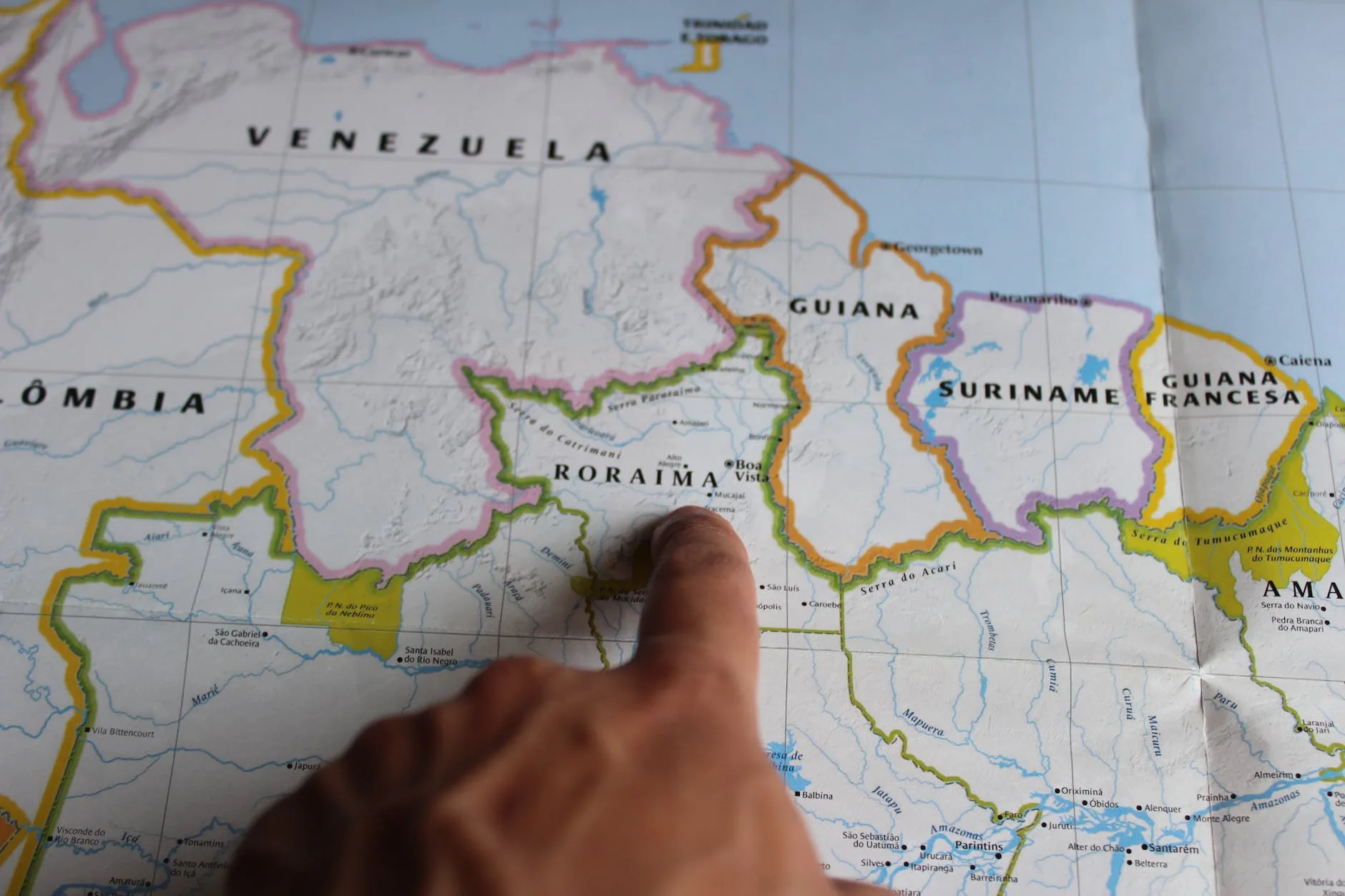 a person pointing at a map with a finger